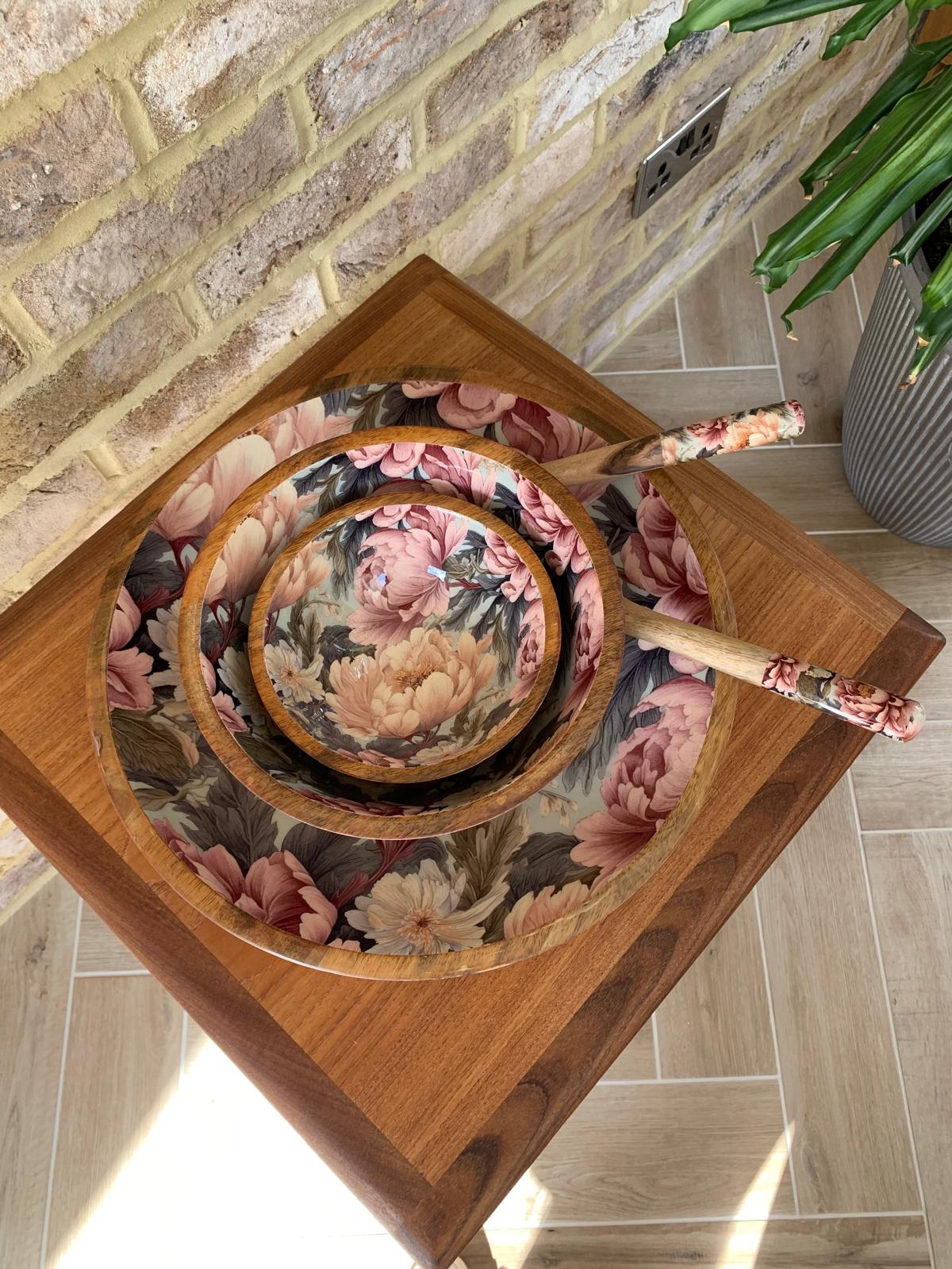 Small, Medium and large bowl with matching salad servers. This design features unfurling peonies in dusty rose pink & cream hues. Also featuring subtle tones of grey & green. Made from sustainable mango wood