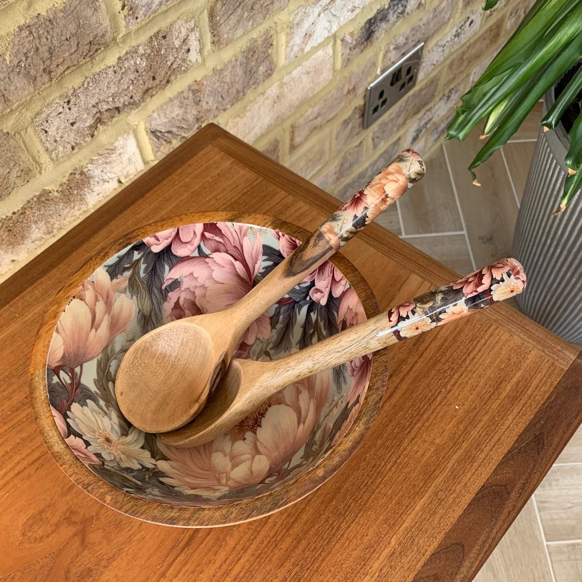 Medium bowl with matching salad servers.  This design features unfurling peonies in dusty rose pink & cream hues.  Also featuring subtle tones of grey & green. Made from sustainable mango wood