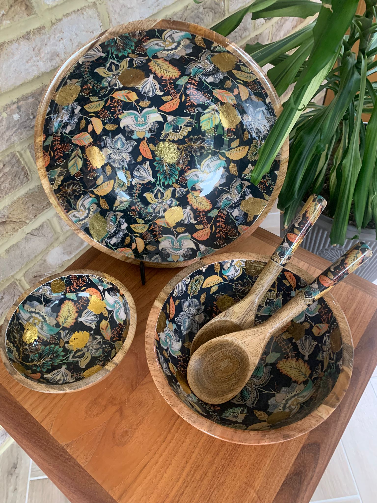 Small, medium and large bowls with matching salad servers.  This elegant floral design in black features stunning accents of gold foil. made from sustainable mango wood