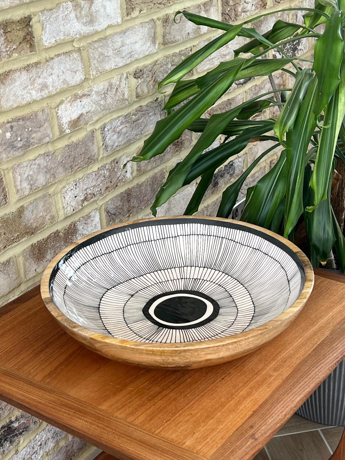 Black and white abstract circles design on a large bowl (38cm diameter) made of sustainable mango wood.  For use to serve cold food or as a stunning decorative home interiors piece