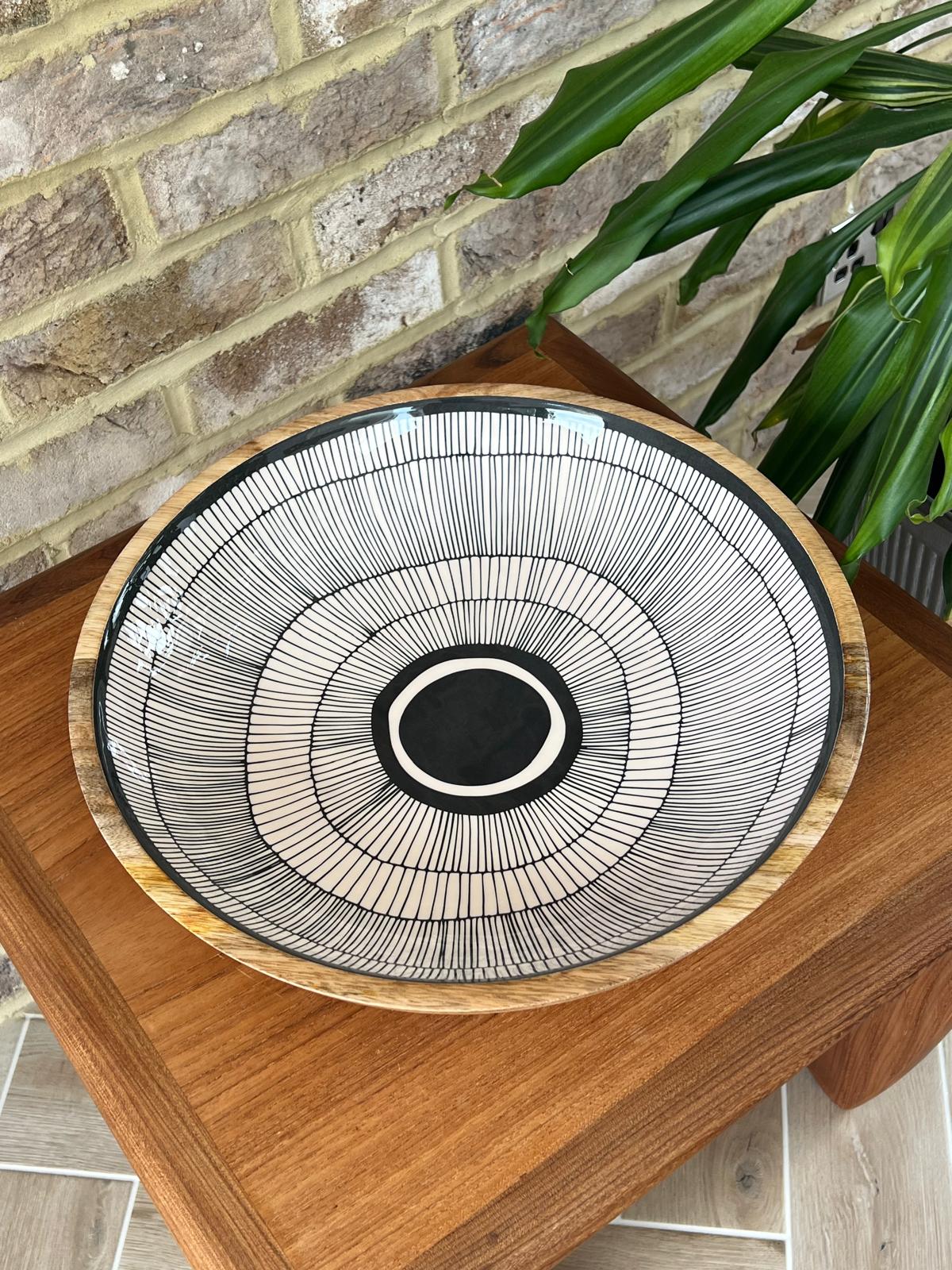 Black and white abstract circles design on a large bowl (38cm diameter) made of sustainable mango wood.  For use to serve cold food or as a stunning decorative home interiors piece