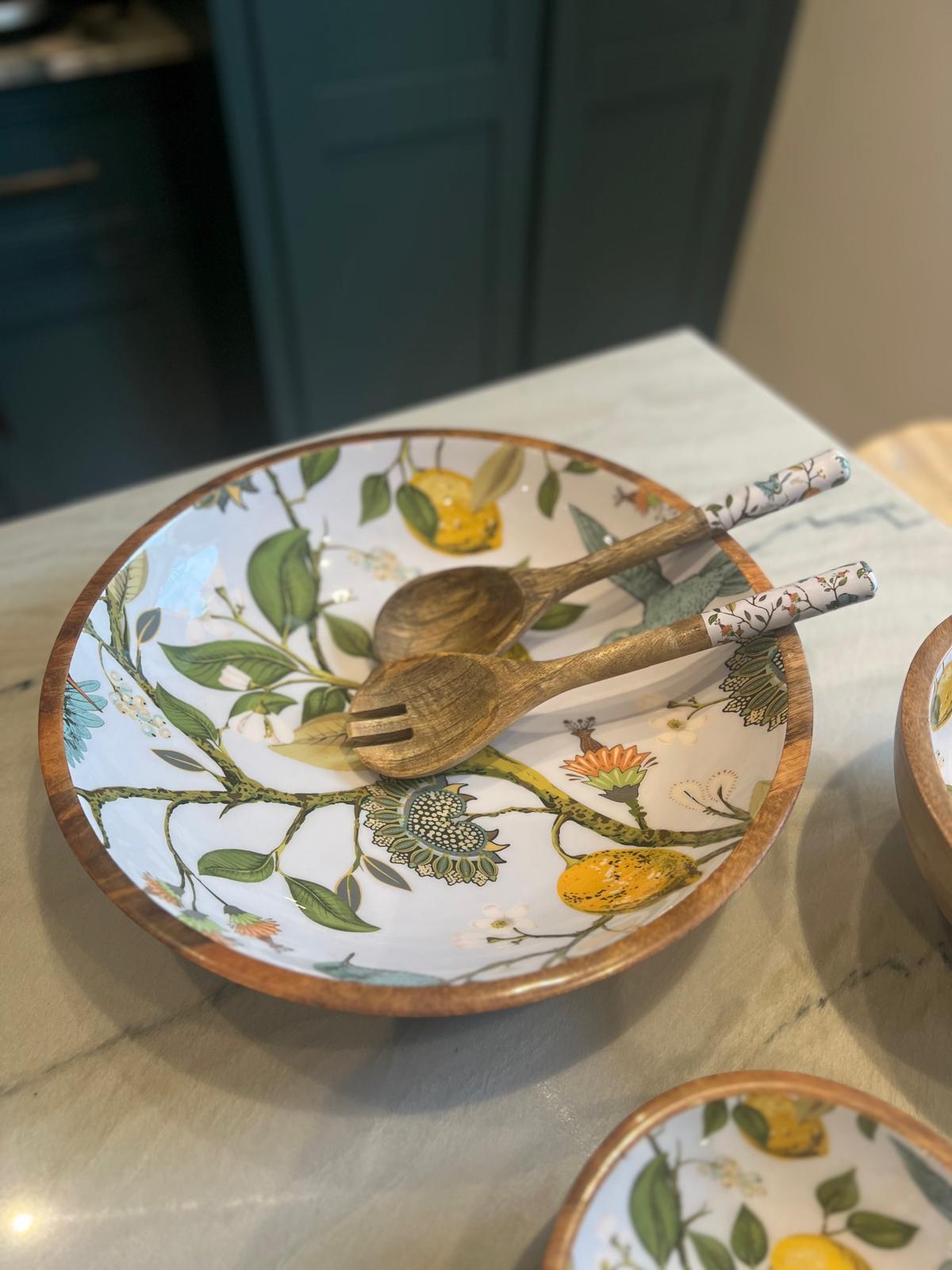 Large statement bowl featuring a lemon bird design.  With matching salad servers.  Suitable for summer dining.  Hand-made from sustainable mango wood