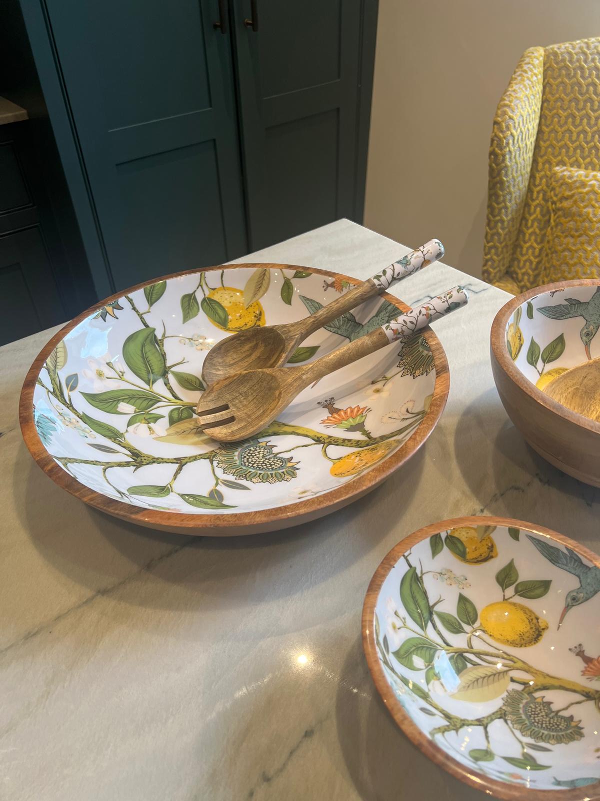 Large statement bowl featuring a lemon bird design.  Suitable for summer dining.  Hand-made from sustainable mango wood