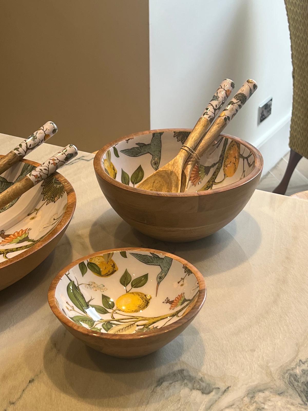 Medium bowl featuring a lemon bird design.  Suitable for summer dining.  Matching small and large variants and salad servers.  Hand-made from sustainable mango wood