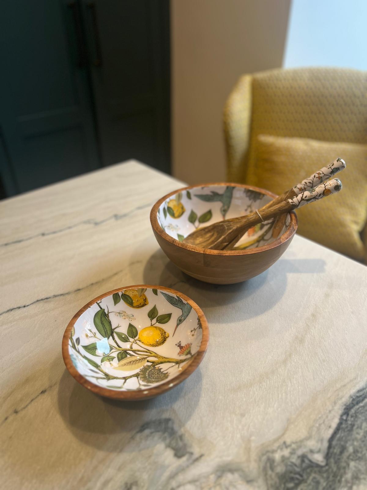 Small and medium sized bowl featuring a lemon bird design.  With matching salad servers.  Suitable for summer dining.  Hand-made from sustainable mango wood