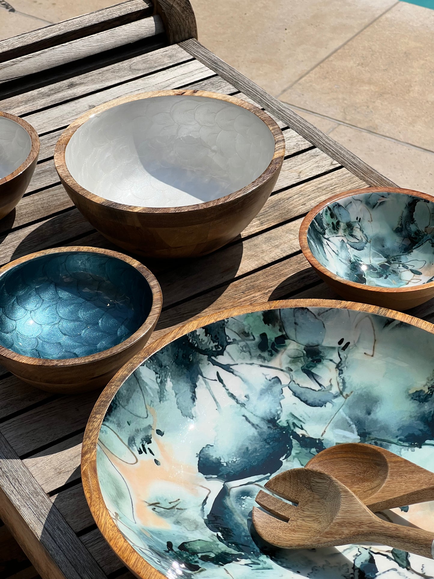 Set of hand-painted white and blue small bowls alongside a blue marble decorated large and small bowl
