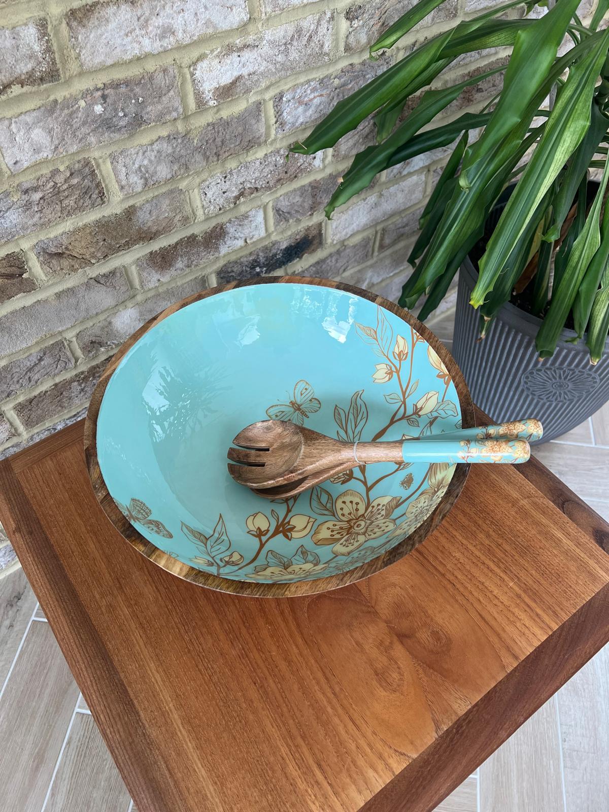 Large salad bowl (35cm diameter) with a decorated food safe enamel coating. Teal background and japanese style design incorporating magnolia and butterflies.  Matching salad spoon & fork with decorated handles.