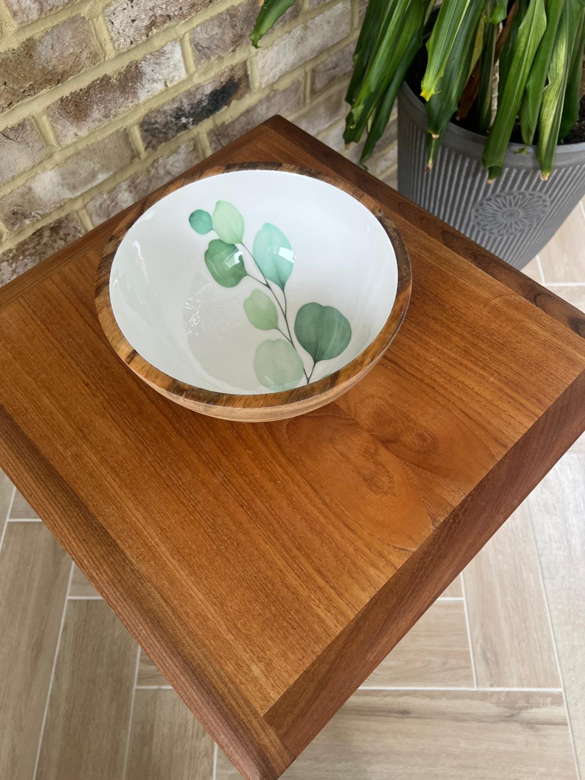 Round medium sized bowl with green eucalyptus leaf design on a white background.  Suitable for cold and warm food.  Salad bowl. Bowl size 25cm diameter.  Made from sustainable mango wood.
