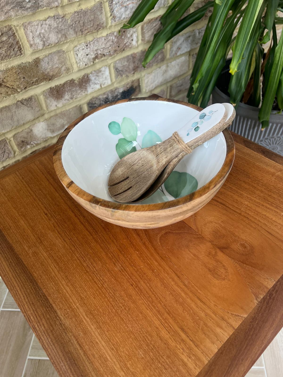 Round medium sized bowl with green eucalyptus leaf design on a white background.  With matching salad spoon and fork.  Suitable for cold and warm food.  Salad bowl. Bowl size 25cm diameter.  Made from sustainable mango wood.