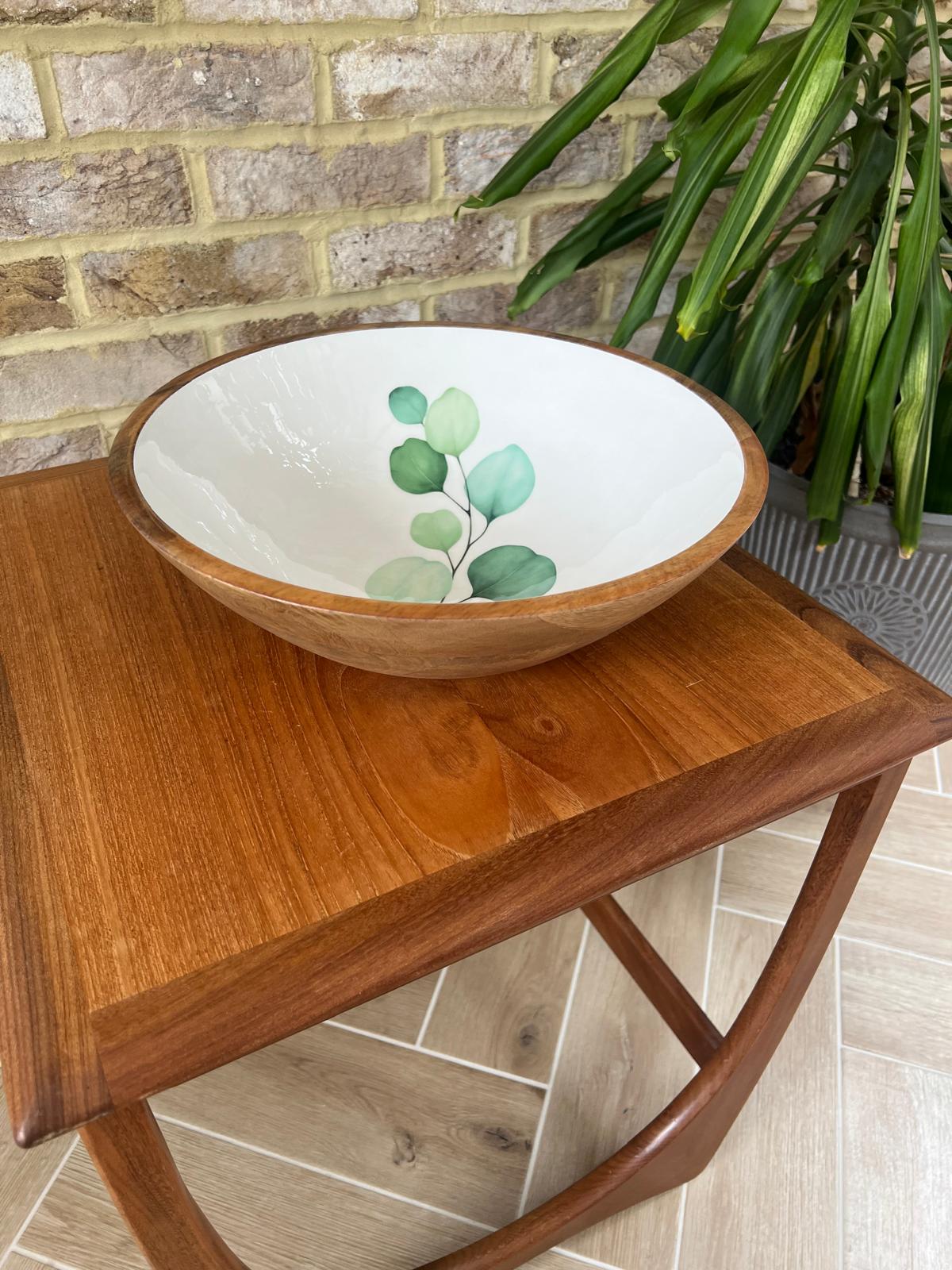 Round large sized bowl with green eucalyptus leaf design on a white background.  Suitable for cold and warm food.  Salad bowl. Bowl size 35cm diameter.  Made from sustainable mango wood.