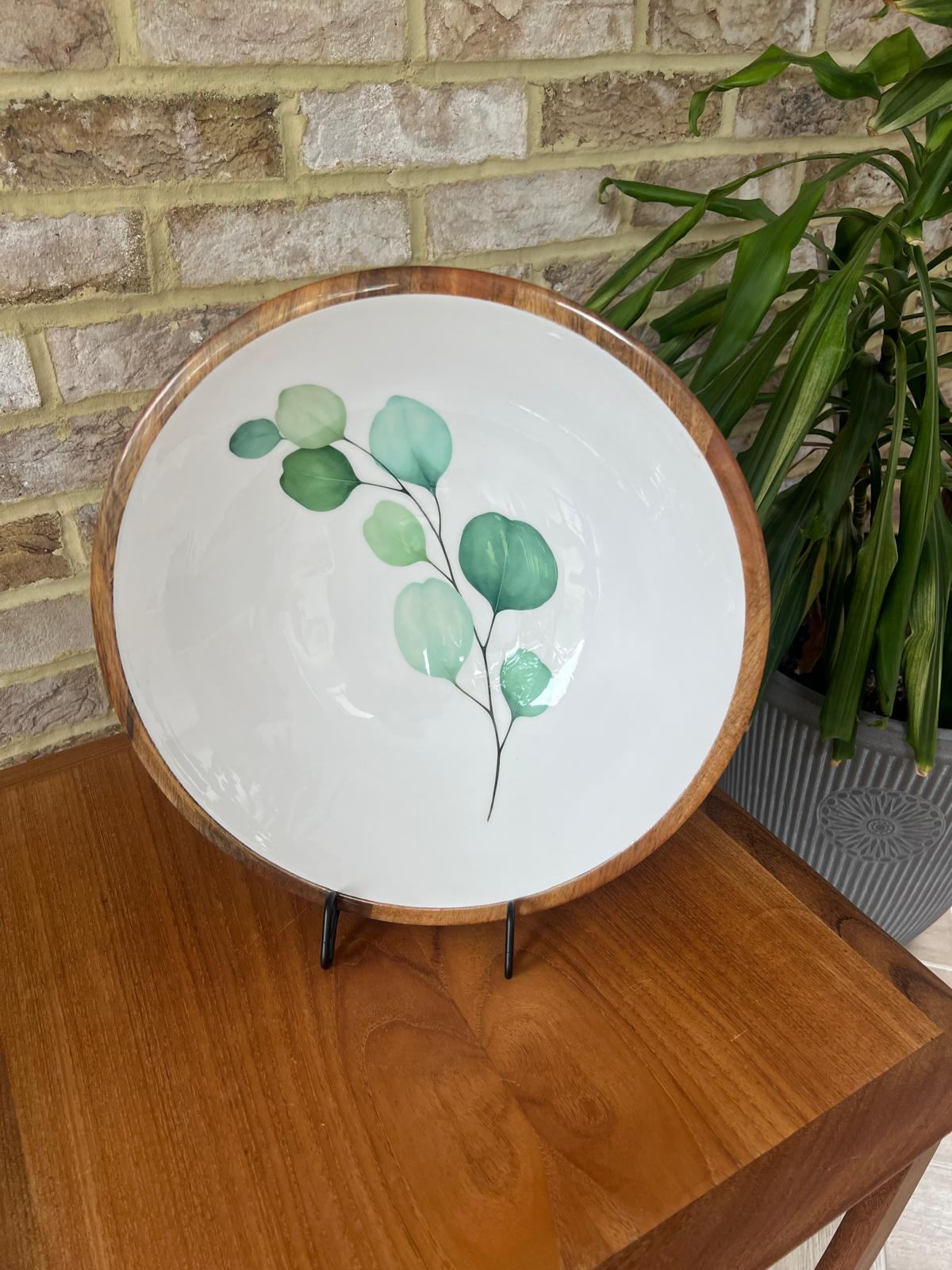 Round large sized bowl with green eucalyptus leaf design on a white background.  Suitable for cold and warm food.  Salad bowl. Bowl size 35cm diameter.  Made from sustainable mango wood.