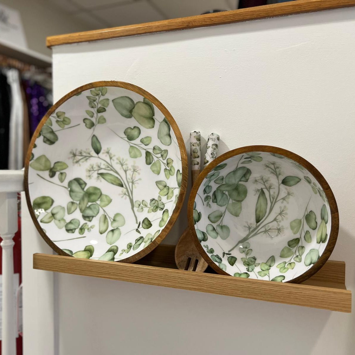 medium sized bowl made from sustainable mango wood with a white background and green leaves design