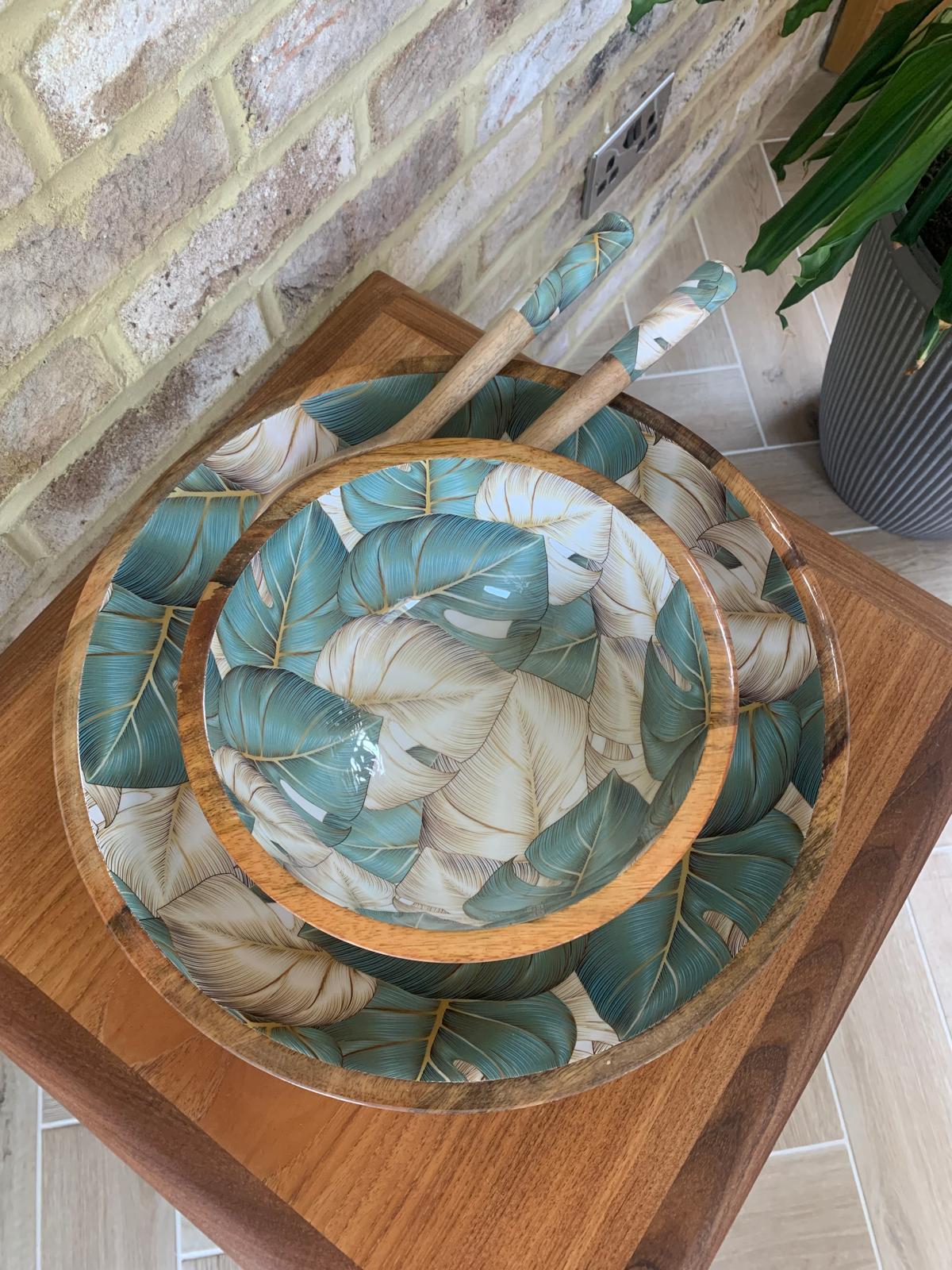 Medium and large bowl with matching salad servers.  Monstera cheese plant design in blue / green and light beige.  Made from sustainable mango wood