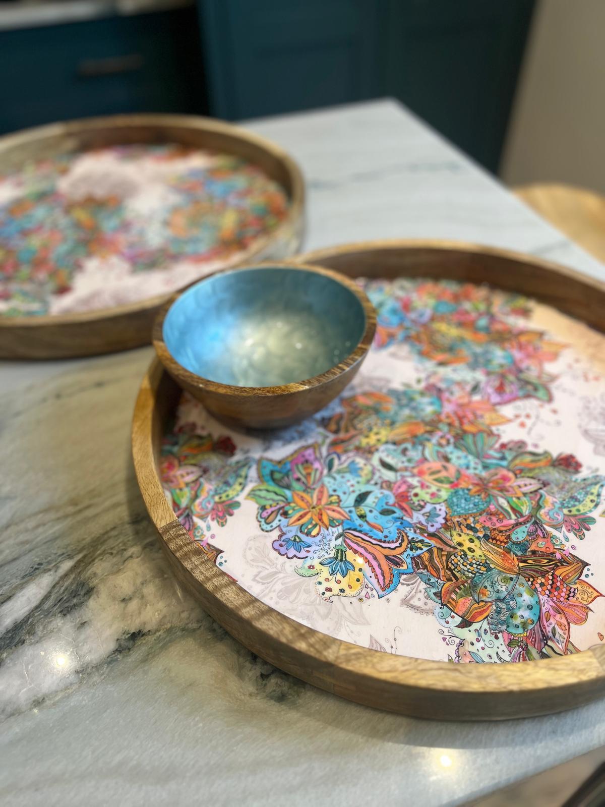 Multi-coloured floral pattern on a tray made from sustainable mango wood.  Matching tray and small hand-painted  blue bowl with fish scales design. 